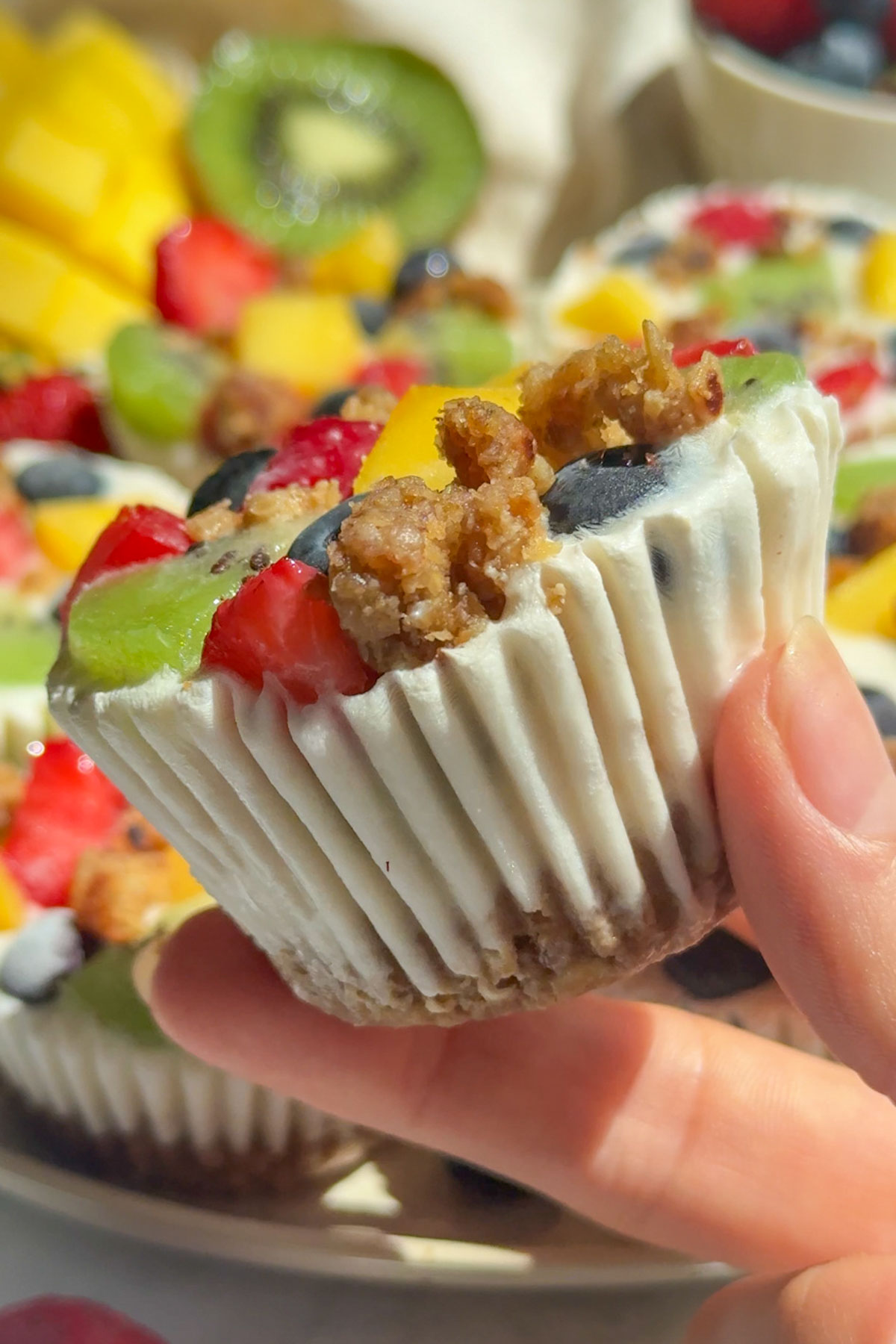 A hand holding up a frozen yogurt cup.
