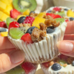 Hands holding up a frozen yogurt cup.