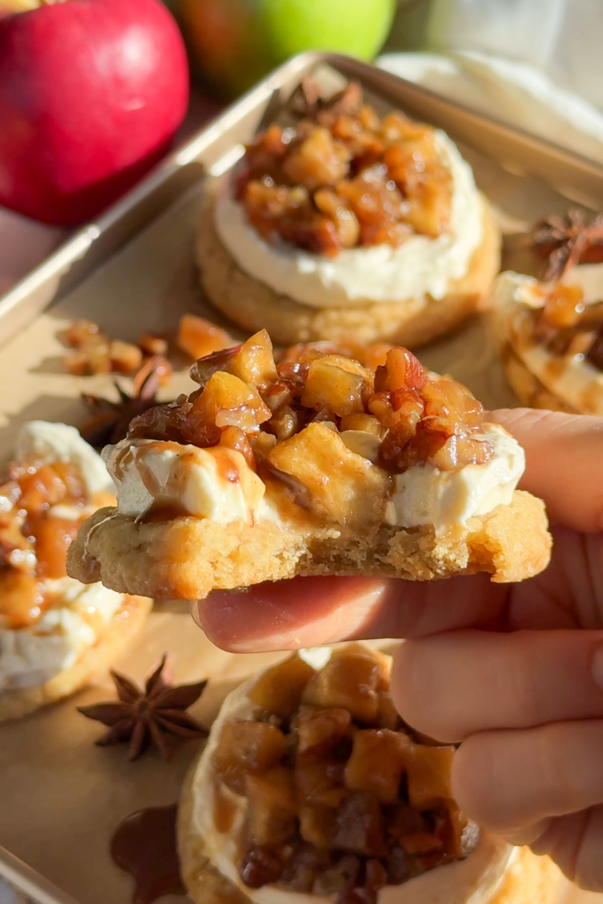 A bite taken out of the apple cheesecake cookie.