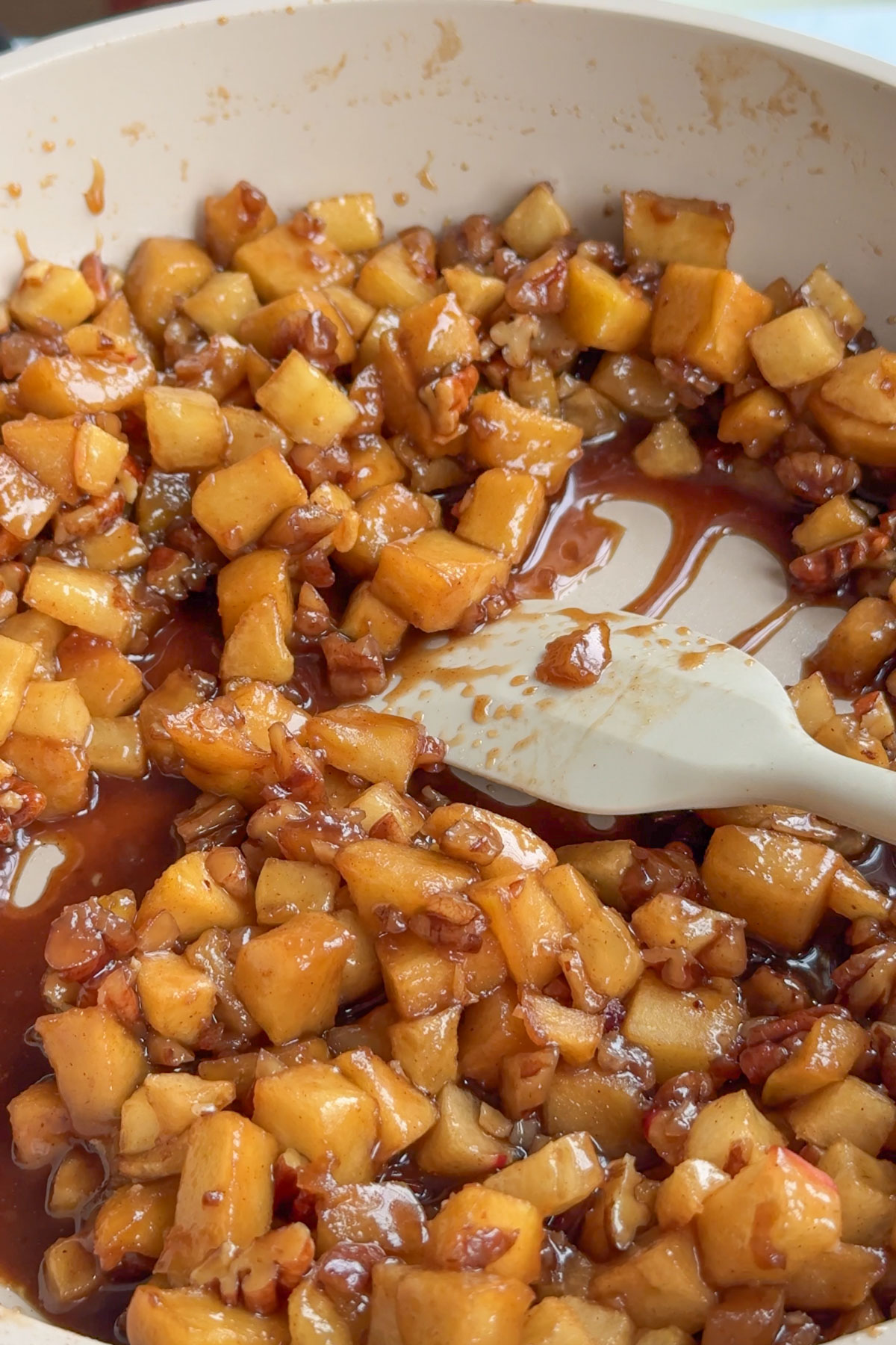 The apples cooking in a pan.
