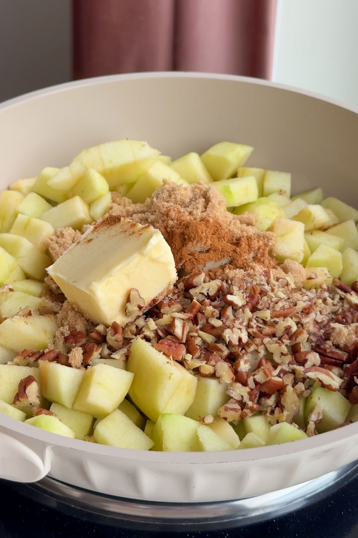Butter melting over top of the apple pecan filling.