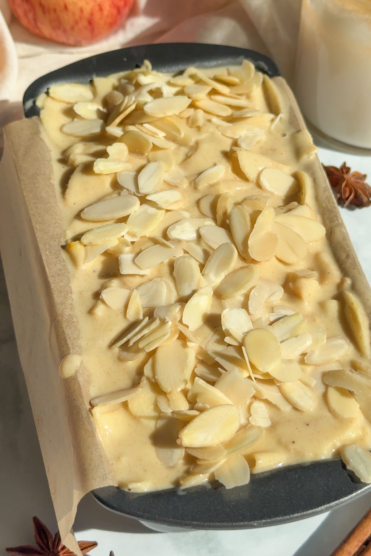 Almond slices added on top of the cake batter.