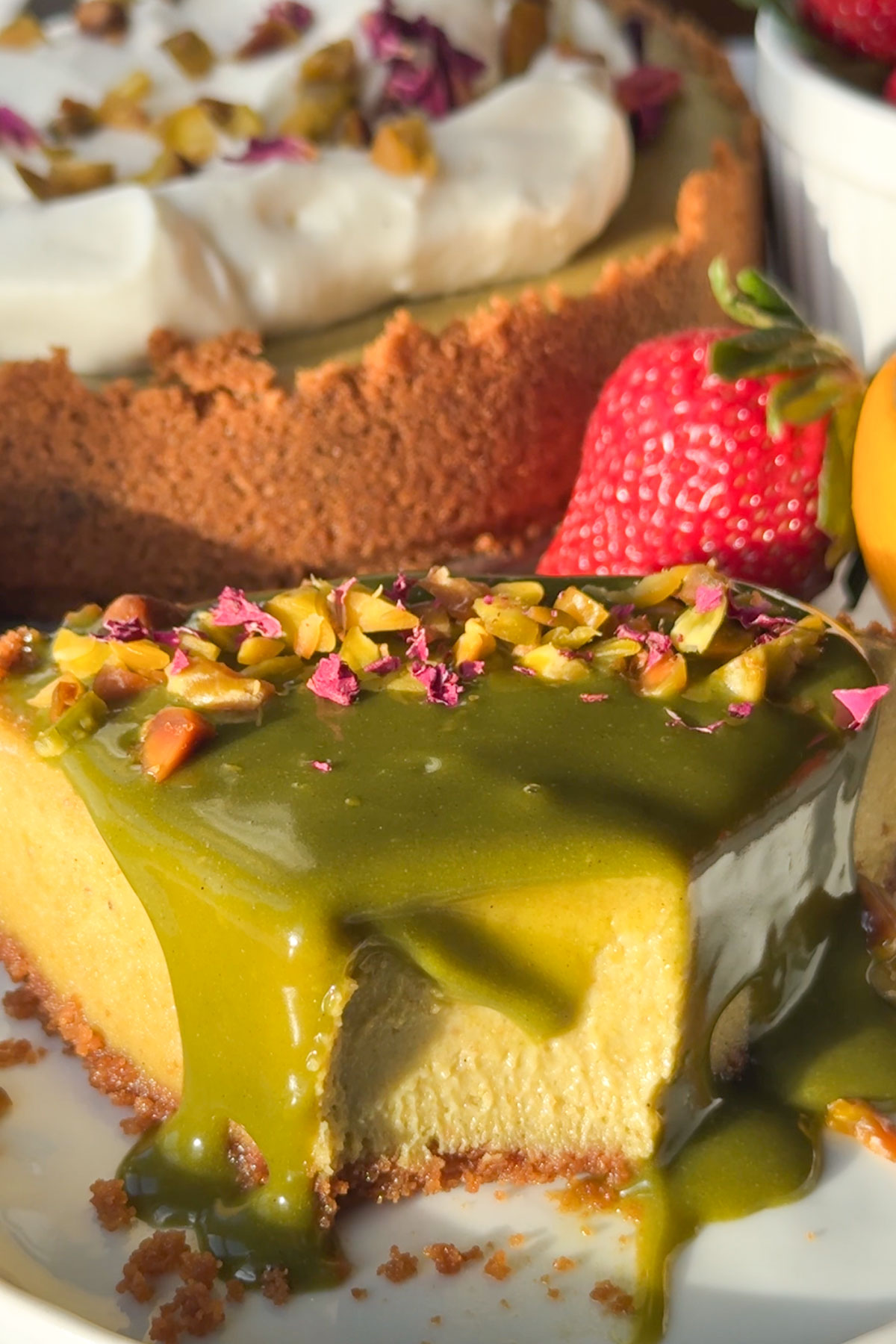 Pistachio cheesecake with a bite missing.