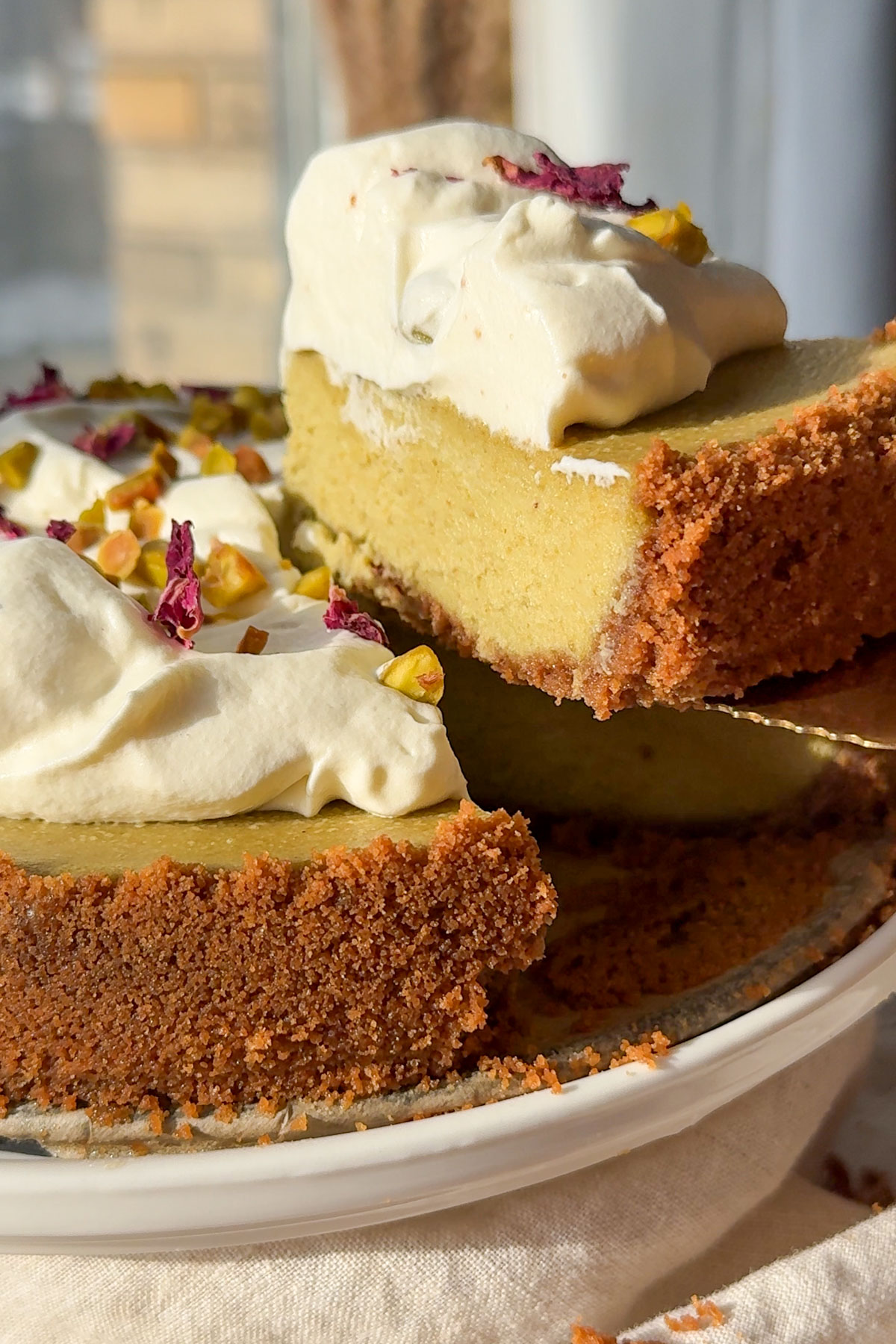 A slice of decorated cheesecake being served.