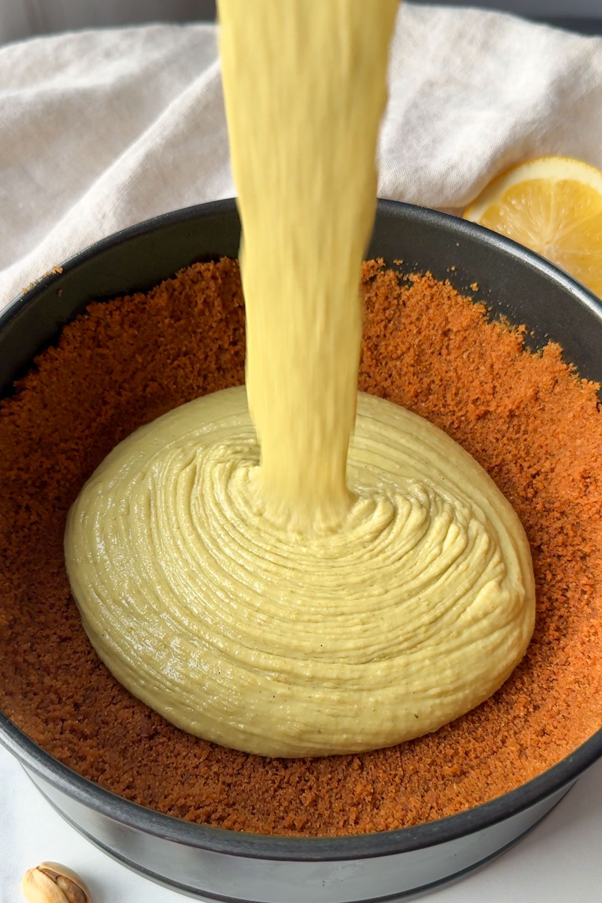 Cheesecake filling poured over the pressed pie crust.