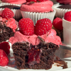 The inside of raspberry chocolate cupcakes cut open on a plate.
