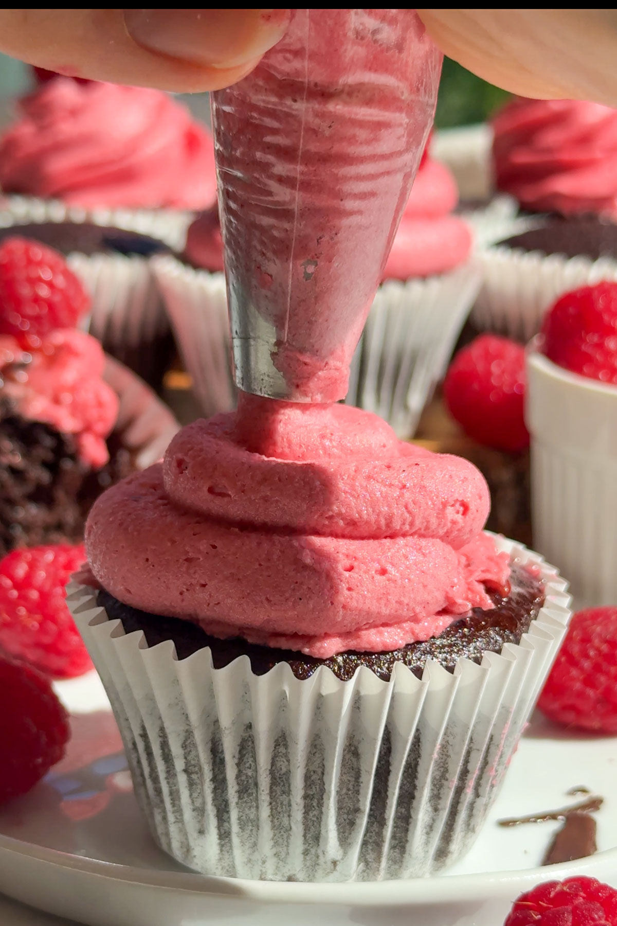 Icing being put on the top of the cupcake.