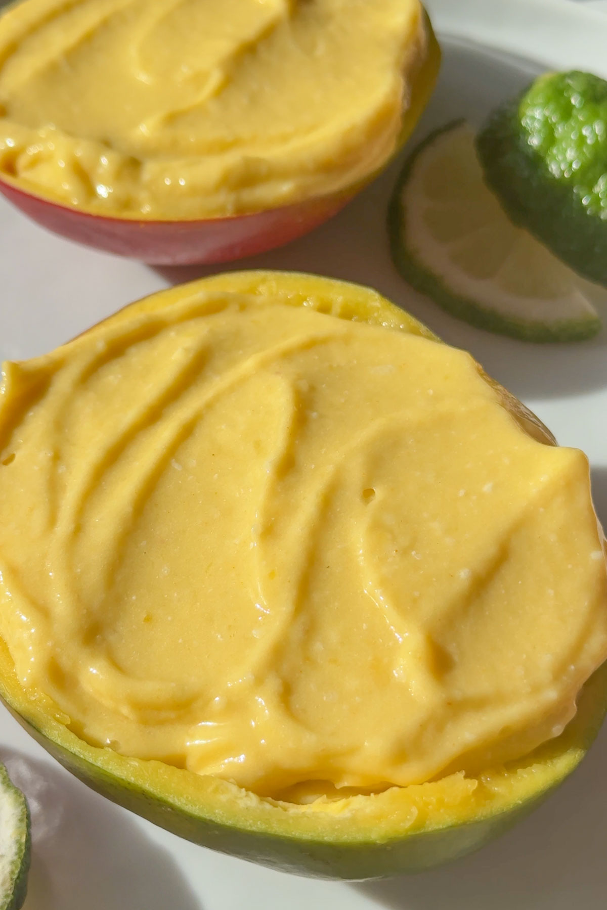 Vegan mango ice cream served in a half of mango used as a bowl.