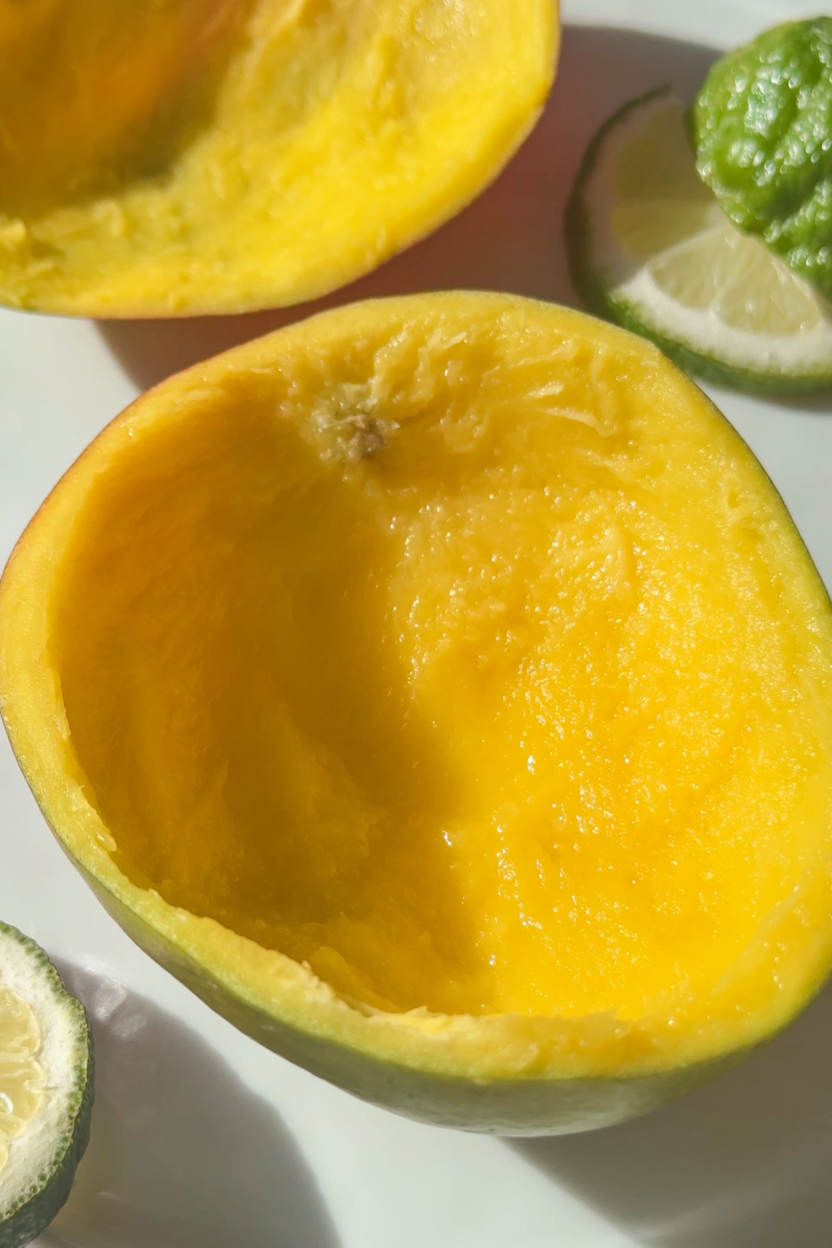 A half of mango with all the fruit scooped out.