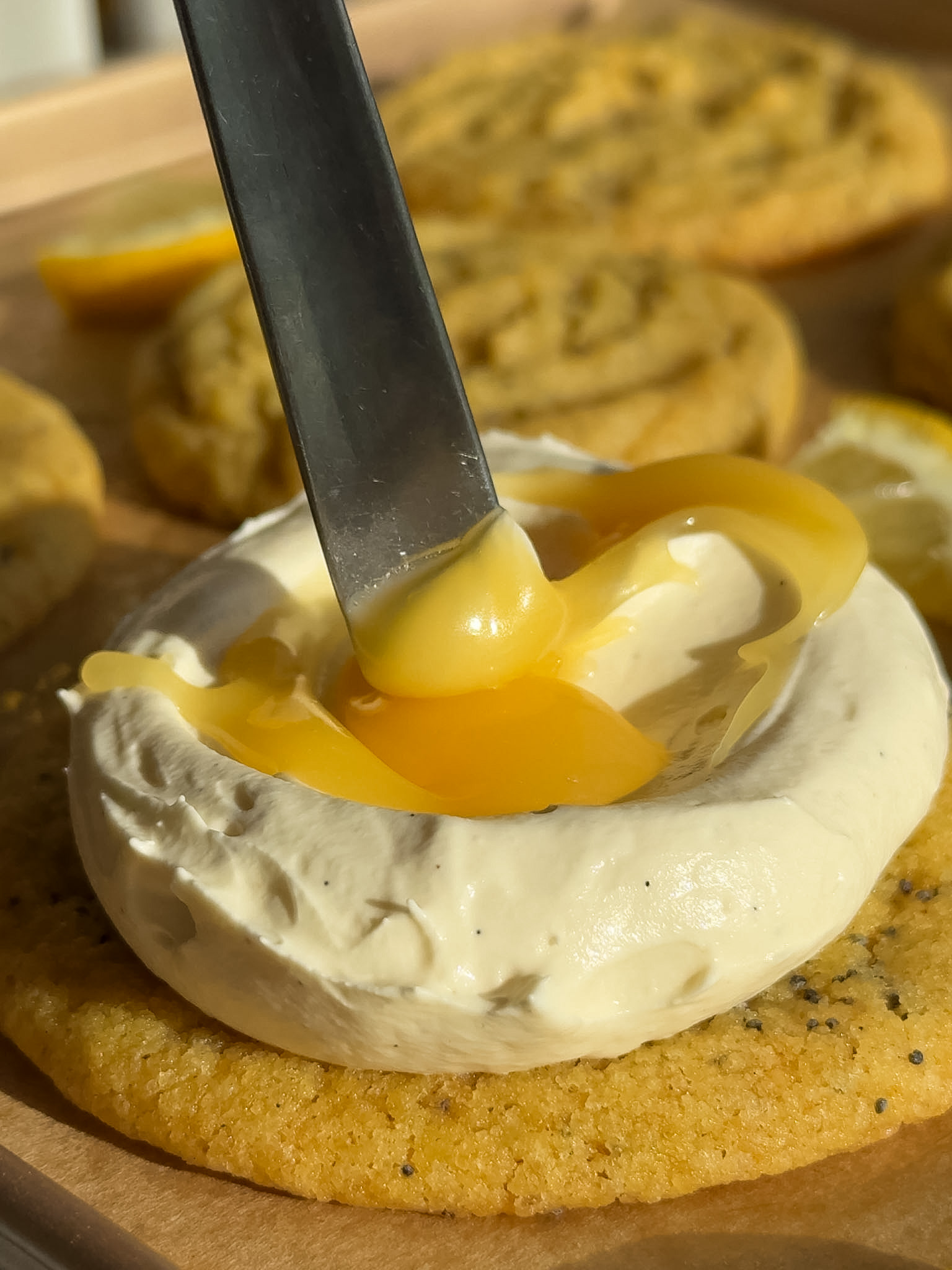 Cheesecake topping and lemon curd on top of the cookie.