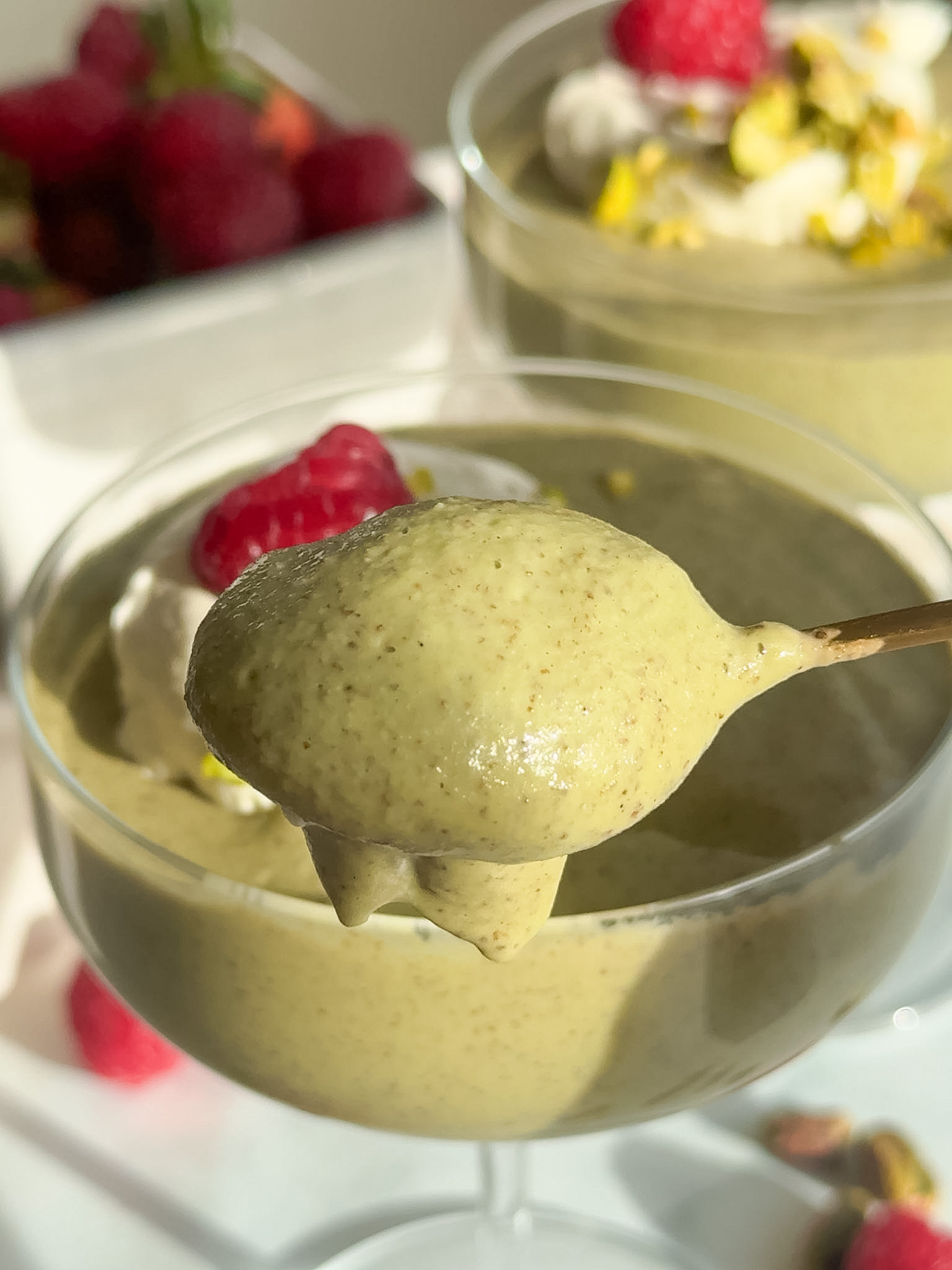 A spoon taking out some pistachio chia pudding.